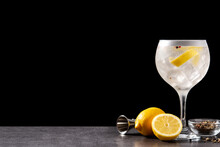 Gin Tonic Cocktail Drink Into A Glass On Black Background. Copy Space