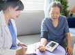 © Tom Wang - Asian caregiver doctor examine older patient use blood pressure gauge.