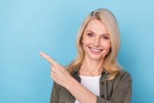 Portrait Of Positive Middle Aged Lady Point Finger Empty Space Present Promo Ads Isolated Blue Pastel Color Background