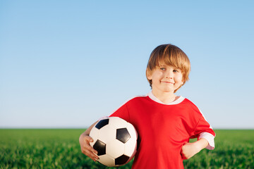 Wall Mural - Child is pretending to be a soccer player