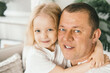 © Zireael - A little girl 4 years old gently hugs her dad.
