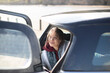 © Caia Image - Happy woman relaxing at back of car