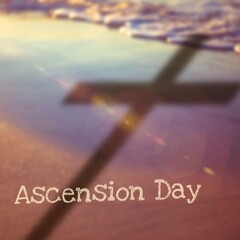 Wall Mural - Ascension day text with shadow of cross on shore at beach, copy space