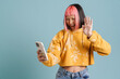canvas print picture Asian girl with pink hair gesturing while taking selfie on cellphone