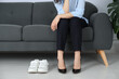 © New Africa - Comfortable sneakers near businesswoman wearing high heel shoes indoors, closeup