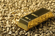 One gold ingot on nuggets, closeup view. Space for text