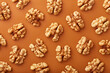 Wallnuts pattern viewed from above on a orange background. Top view