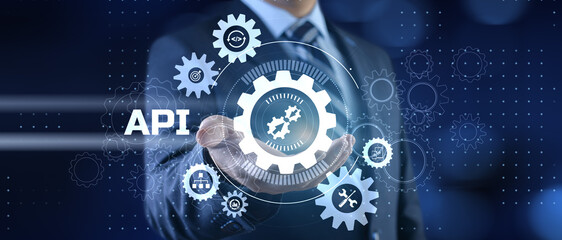 API Application programming interface. Businessman pressing virtual button.