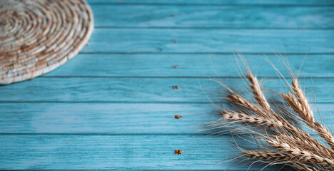 Wall Mural - Close up of wheat ears ans wicker straw stand