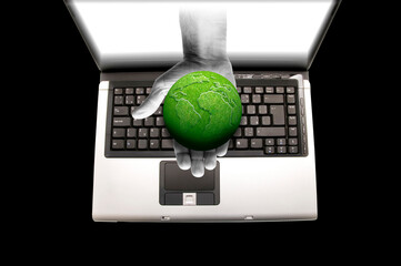 Wall Mural - hand out of a laptop screen holding a green planet Earth, green world and Earth day concept