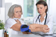 © aletia2011 - Female doctor measures the pressure her senior patient