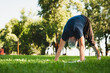 © InsideCreativeHouse - Caucasian mature fit healthy man in sporty clothes doing yoga exercises outdoors , standing in yoga position on green grass in public park