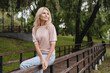 © InsideCreativeHouse - Cropped closeup portrait of a caucasian mature beautiful blonde woman wife walking alone in park forest outdoors spending free time in woods.