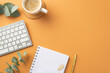 © ActionGP - Business concept. Top view photo of workplace white keyboard organizer gold pen clips cup of coffee on rattan serving mat and eucalyptus leaves on isolated orange background with copyspace