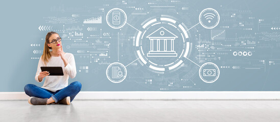 Wall Mural - Online banking concept with young woman holding a tablet computer