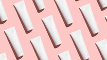 Pattern From Mock Up Cosmetic Tubes On Pink Background