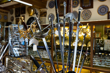 Wall Mural - Various handcrafted swords and daggers displayed in artisan shop of Toledo. Traditional travel souvenirs concept..