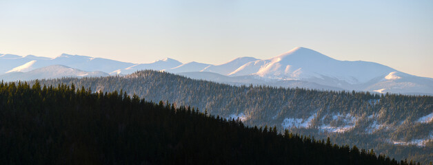 Canvas Print - Panoramic mountain landscape with snowy high peaks and wooded valley