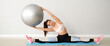 © Pixel-Shot - Sporty young woman doing exercises with fitball in gym