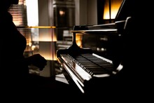 Elegant Woman Playing On Piano, Dark Photo