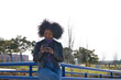 © @skuder_photographer - Young, beautiful Afro-American woman with mobile phone shopping online, checking her email and social networks in the park. The woman is wearing casual and comfortable clothes and is happy.