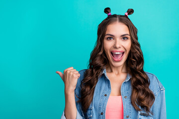 Poster - Photo of young excited girl indicate finger empty space follow direct select isolated over turquoise color background