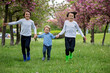 © Tomsickova - Happy children of different age groups, running together in the park, springtime, having fun