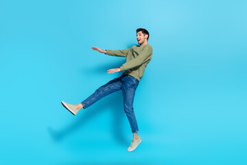 Wall Mural - Full size photo of satisfied cheerful person falling jumping flight isolated on blue color background