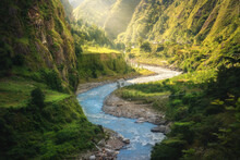 Colorful Landscape With High Himalayan Mountains, Beautiful Curving River, Green Forest, Grass, Yellow Sunlight At Sunrise In Summer. Mountain Canyon In Nepal In Spring. Travel In Himalayas. Nature
