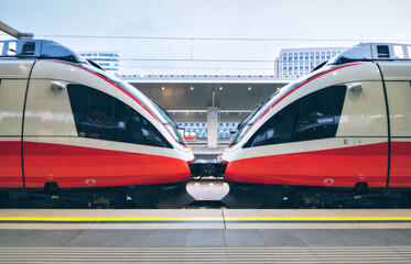 Wall Mural - high speed train in motion on the railway station at sunset