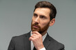 © NFstock - Thoughtful businessman standing with hand near his face and pondering about something. Occupation concept