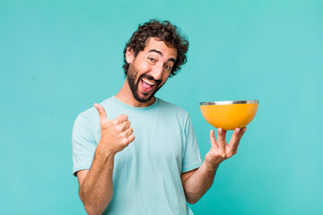 Wall Mural - young adult hispanic crazy man holding an empty bowl