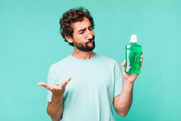 Wall Mural - young adult hispanic crazy man. mouthwash concept