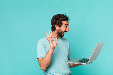 Poster - young adult hispanic crazy man with a laptop