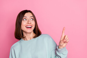 Wall Mural - photo of youth cheerful curious lady point finger empty space ads suggest promo isolated over pink c