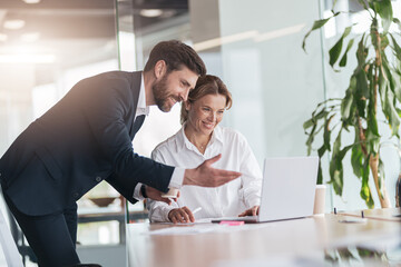 Wall Mural - Female boss discussing online project with employee showing presentation to experienced team leader