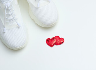 Wall Mural - White textile sneakers on a white background, top view