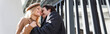 © LIGHTFIELD STUDIOS - low angle view of cheerful couple with closed eyes hugging near fence, banner.