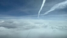 Sky View From A Jet Cockpit During Flight Overflying Clouds And Bellow Another Jet Wake