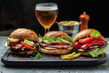 Set of Homemade burger with juicy meat cutlet, vegetables, sauce French fries with beer. fast food and junk food concept