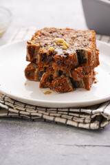 Wall Mural - Slices of Chocolate banana bread with walnuts on a checkered kitchen napkin and ingredients on a grey neutral background