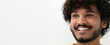 © kucherav - Portrait young happy positive Indian man with white teeth and curly hair smiling broadly on white background, copy space