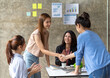 © PaeGAG - Business people shaking hands, finishing up a meeting, business woman asian team partners in the office.