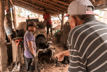 Foreman Giving Orders To A Worker In A Mud Brick Manufacturing Workshop In La Paz Centro, Nicaragua, Latin America.