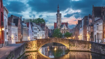 Fototapete - Bruges, Belgium. View of  Spiegelrei canal at dusk (static image with animated sky and water)
