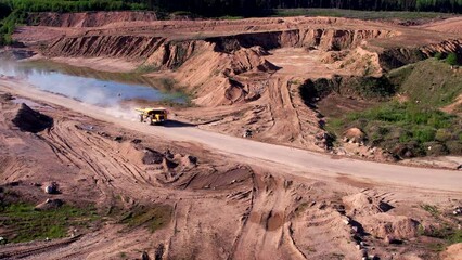 Wall Mural - Mining truck transportation sand in open-pit mine, drone view. Sand transport from open pit. Haul truck in sand quarry. Lorry in opencast. Mining industry concept. Bulk construction supplies.