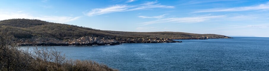 Wall Mural - Panorama of a beach with sand and stones near the Black Sea under sunset light in Bulgaria