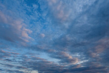 A Picturesque Panorama Of The Evening Cloudy Sky With Gaps Of Blue.