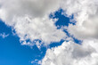 © dotsent - Bright blue sky with white fluffy clouds, for use as an abstract background and textures.