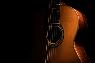 Classical guitar on a black background with copy space